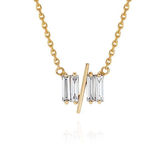 Close up of 11/11 necklace in yellow gold – featuring a thin yellow gold chain, and pendant featuring 4 long thin diamonds, with a thin diagonal gold bar, to look like the ‘11/11’ symbol.
