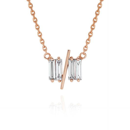 Close up of 11/11 necklace in rose gold - featuring a thin rose gold chain, 4 long thin diamonds, with a thin diagonal gold bar, to make the ‘11/11’ symbol.