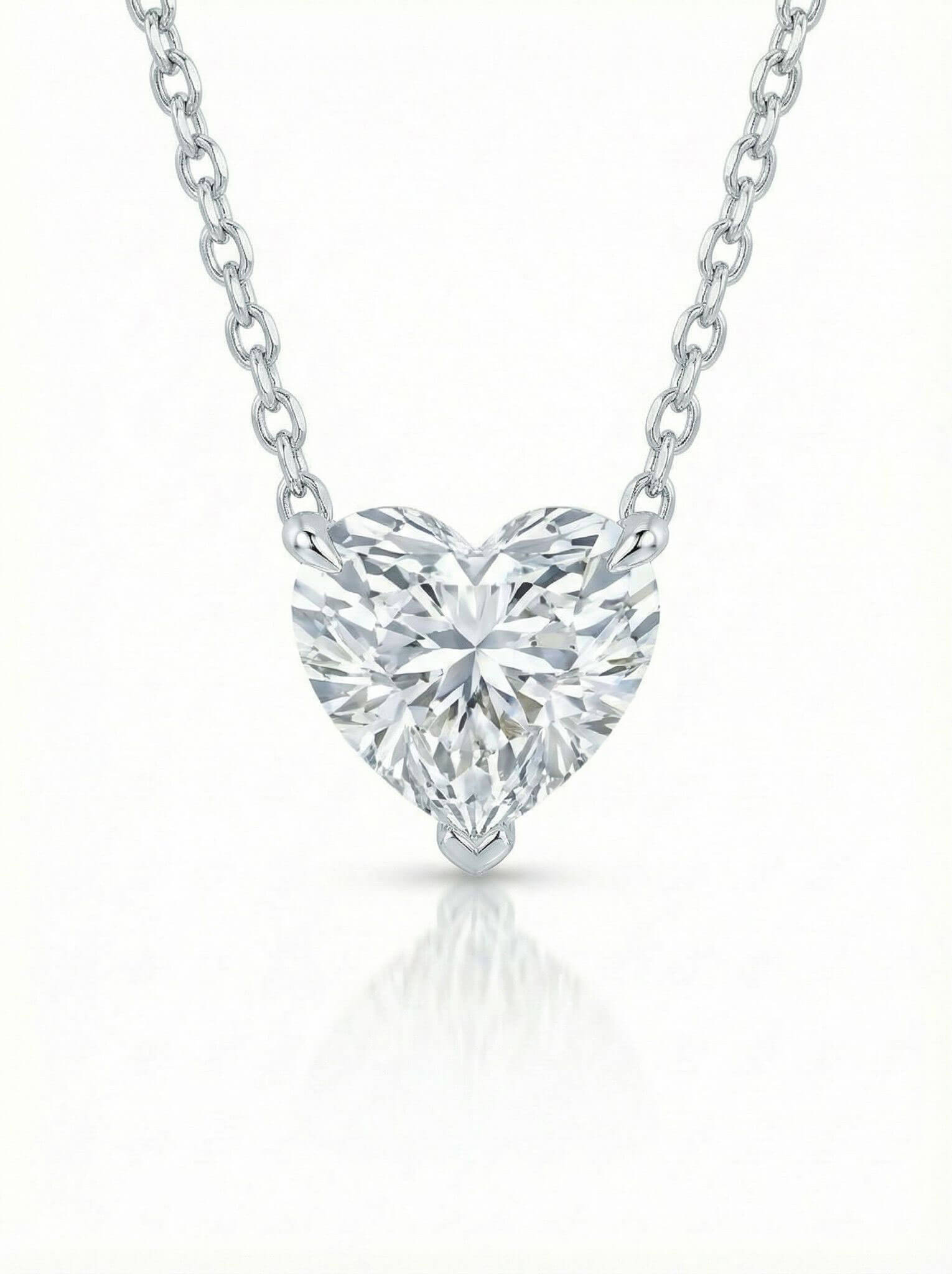 Heart-shaped diamond pendant on a white background
