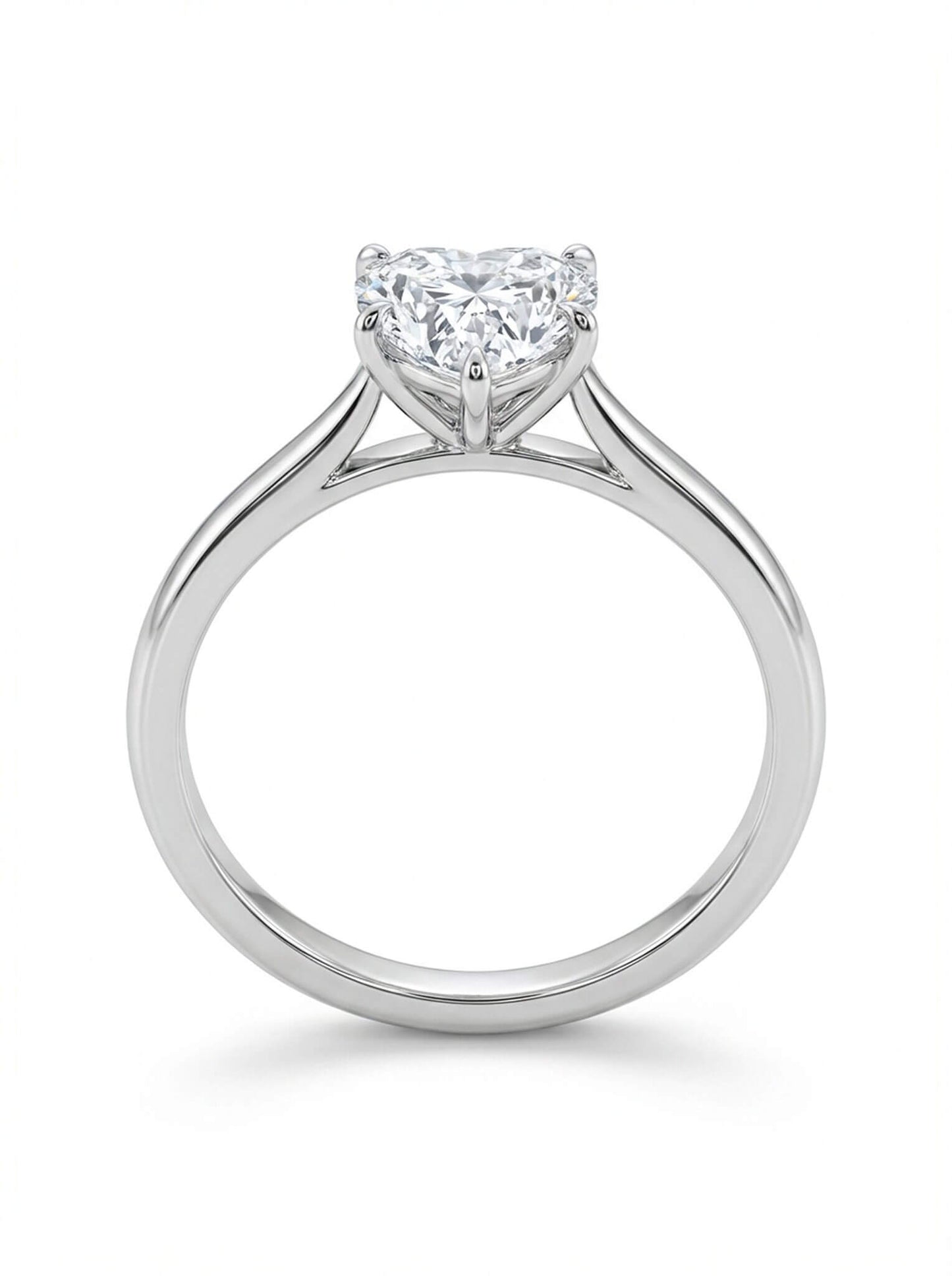 Diamond ring with a heart-shaped center stone on a white background