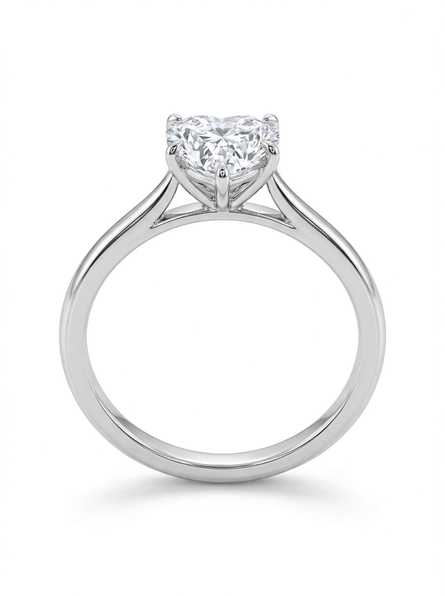 Diamond ring with a heart-shaped center stone on a white background