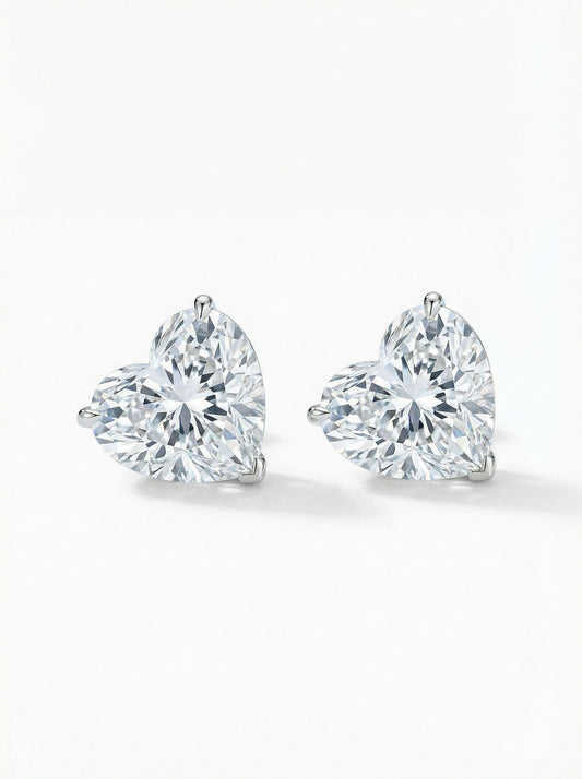 Pair of heart-shaped diamond stud earrings on a white background