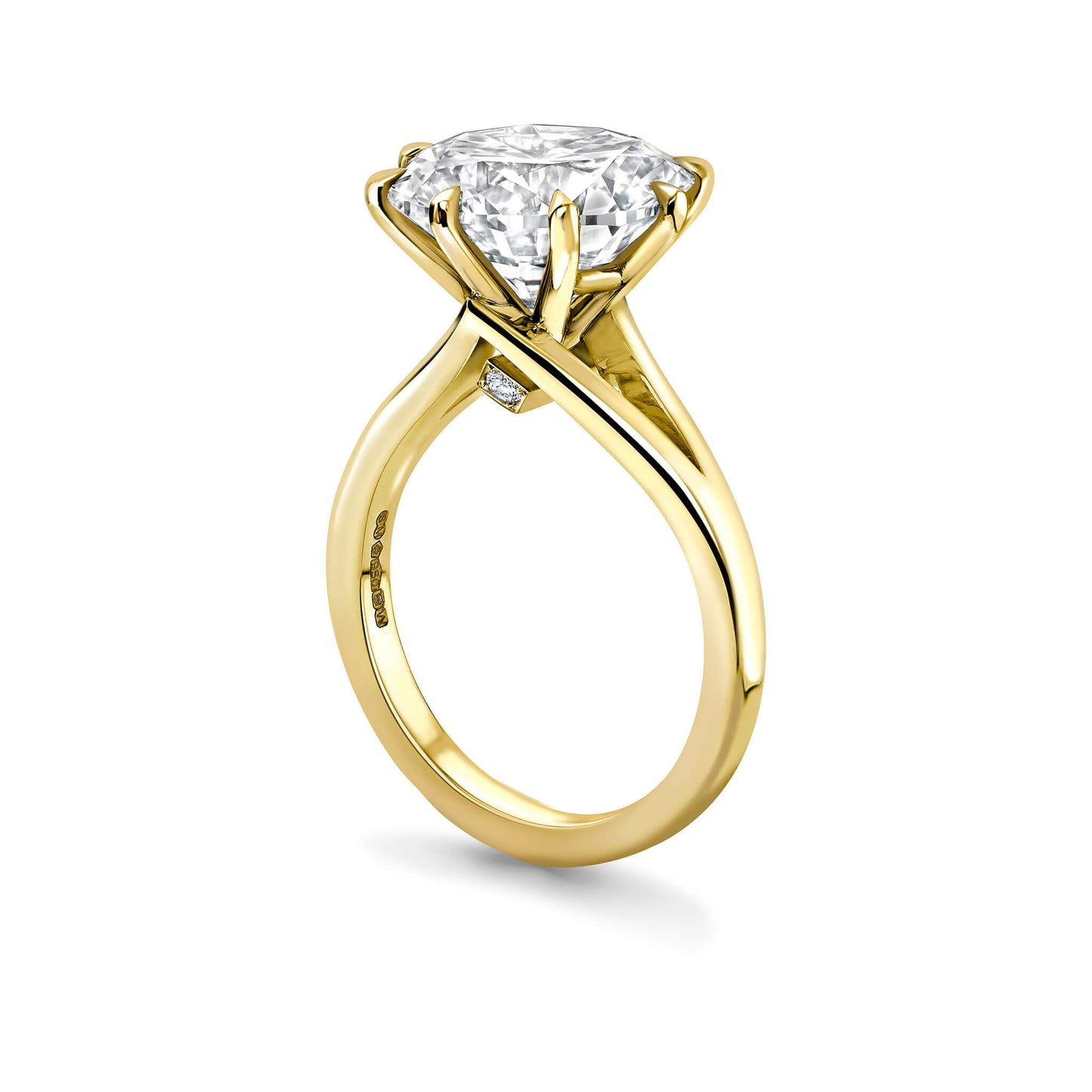 Gold ring with a large diamond on a white background