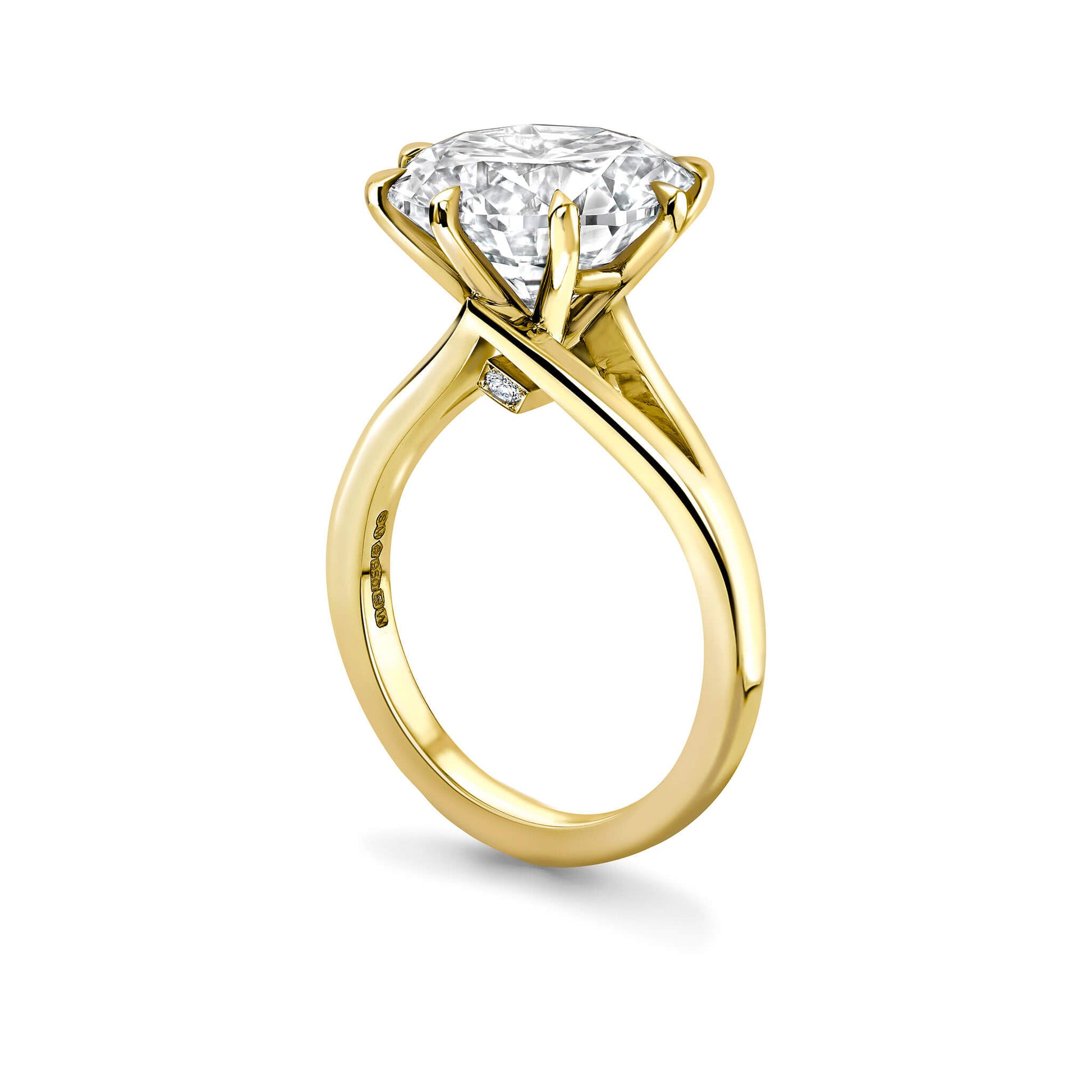 Gold ring with a large diamond on a white background