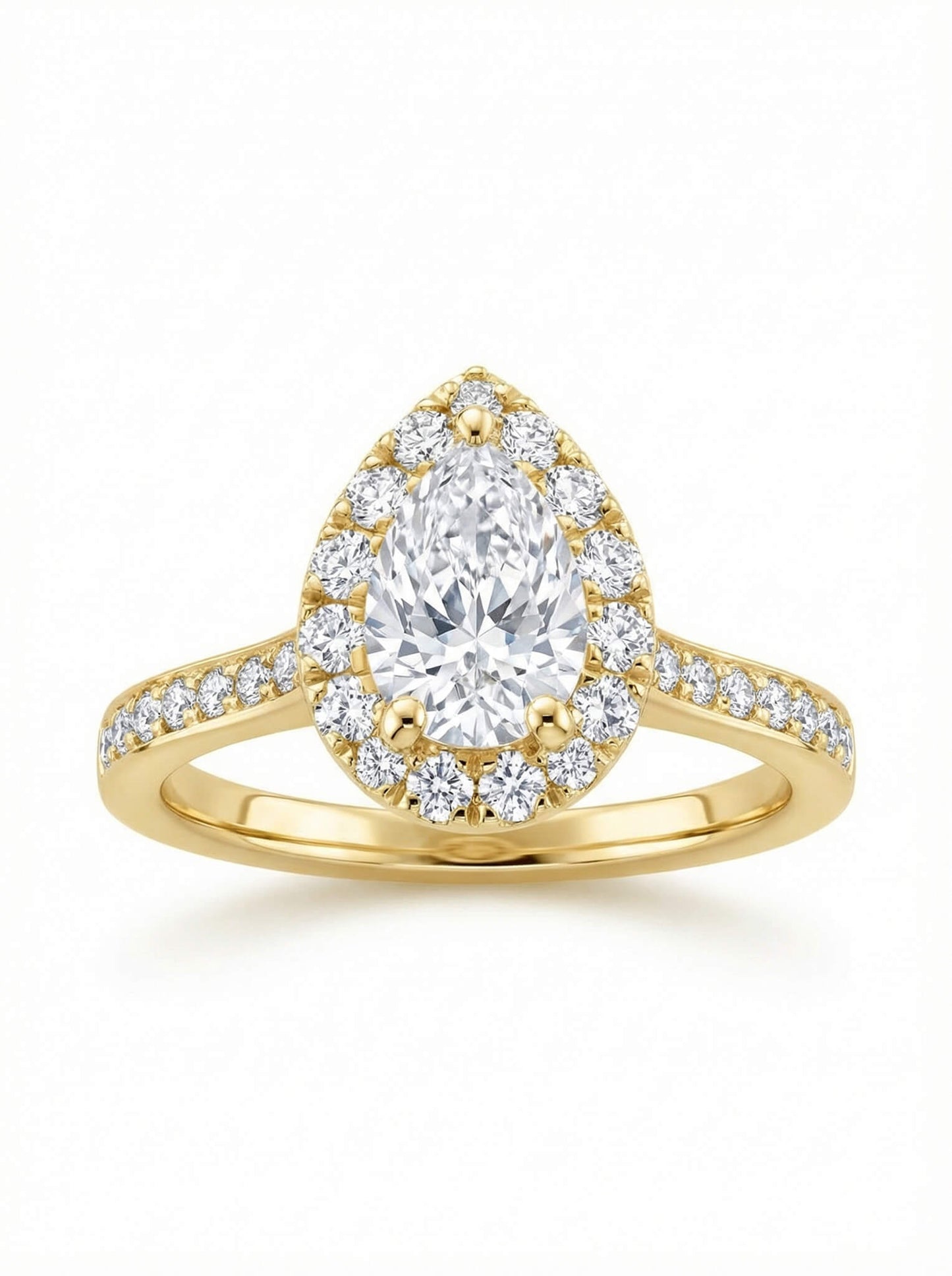 Gold ring with a pear-shaped diamond surrounded by smaller diamonds on a white background.